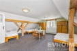 Prostorn� lo�nice s parketovou podlahou a d�ev�n�mi tr�my, sv�tl� d�ky velk�m okn�m, nab�z� pohodln� um�st�n� postel� a �lo�n�ch sk��n�.