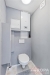 Samostatn� toaleta s modern�m splachovac�m syst�mem, sv�tl� dla�dice a neutr�ln� �ed� st�ny, prostor pro kotel zabezpe�uje funk�nost.