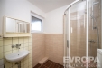 Koupelna s dla�bou v b�ov�ch t�nech, sprchov�m koutem a umyvadlem, modern� a �ist� vzhled, okno pro p�irozen� sv�tlo